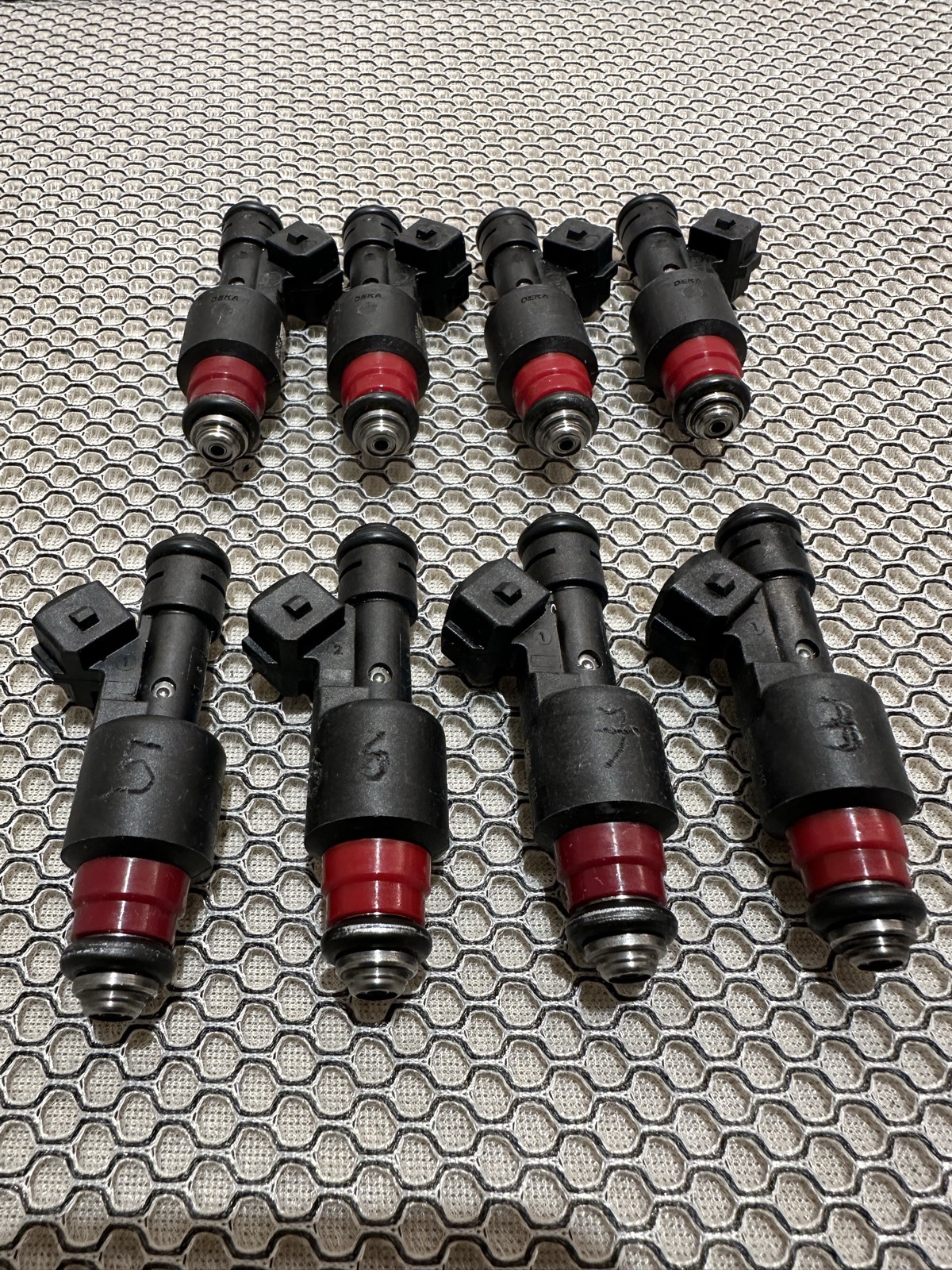 A serviced set of fuel injectors fitted with fresh red Viton O-rings