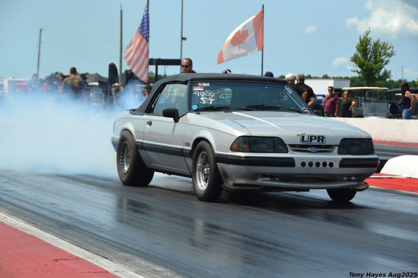 Jeff Bloem's silver Fox-body Mustang doing a burnout at the drag strip