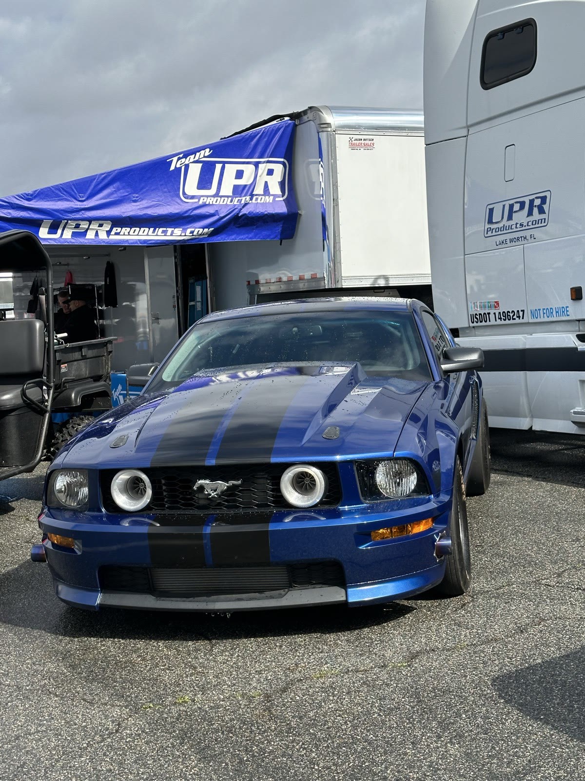 Luke C's blue twin-turbo Coyote Mustang in the pits
