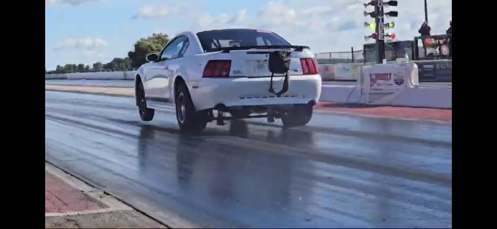 The Underdog Racing shop Mustang carrying the front wheels off the line